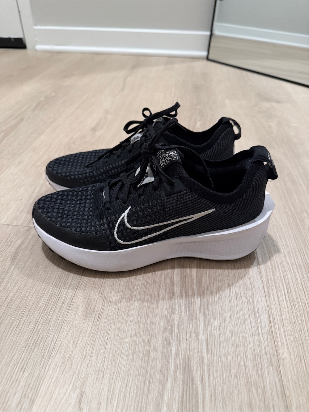 Nike women’s black running Sneakers with White Swoosh